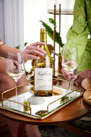 King Estate Pinot Gris Lifestyle with hands in livingroom